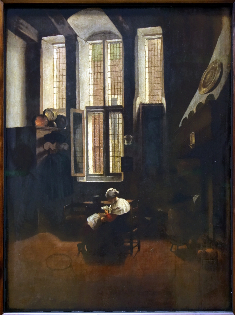 Scène d'intérieur. Une femme assise fait la lecture à un jeune garçon