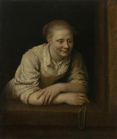Woman Holding a Pearl Necklace In Her Hand