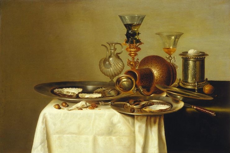 Still life of a laid table with perfume bottle
