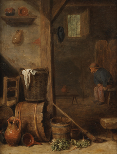 A kitchen interior with a figure seated in the adjoining room