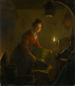 A Woman in a Kitchen by Candlelight by Michiel Versteegh