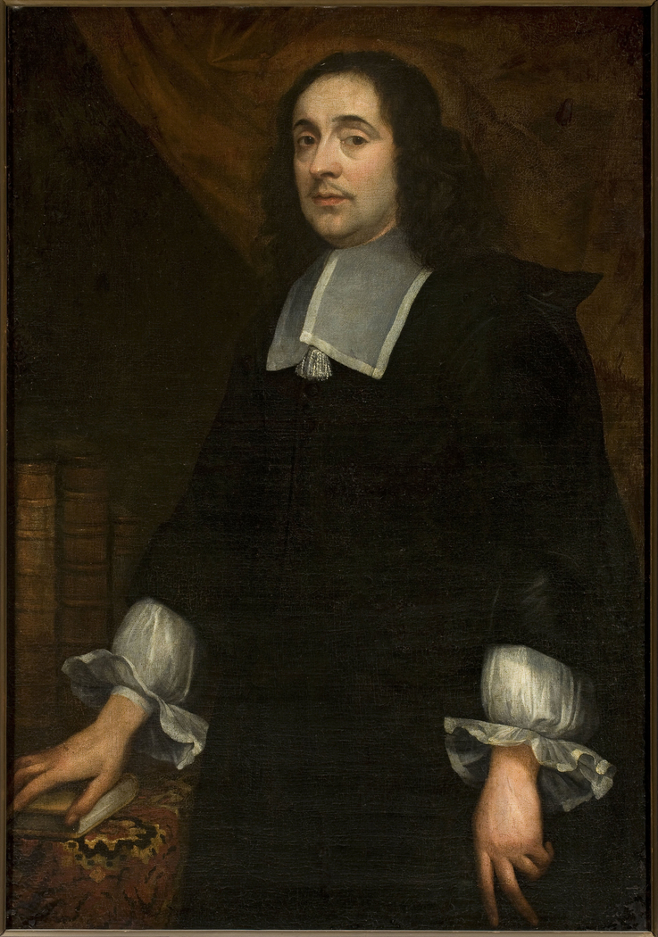 Portrait of a man at the table covered with a carpet
