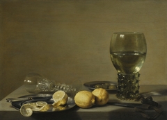 Still Life with Two Lemons, a Facon de Venise Glass, Roemer, Knife and Olives on a Table