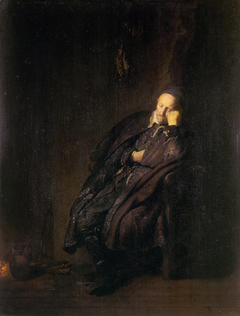 An old man sleeping near the fire