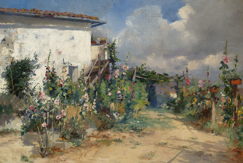 House with hollyhocks in the garden