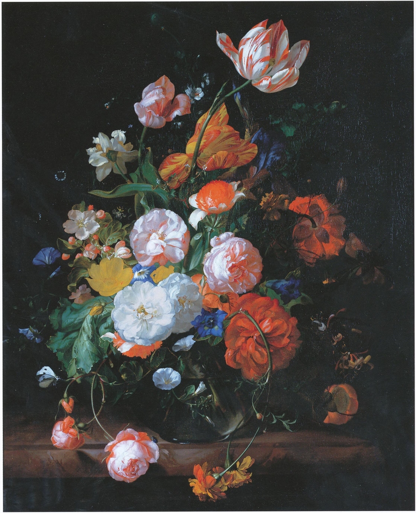 Roses, tulips and other flowers in a glass vase on a marble ledge