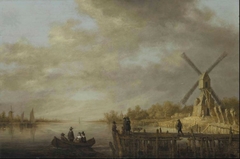 A river landscape with a windmill and gentlefolk in a rowing boat and on a jetty in the foreground by Aelbert Cuyp