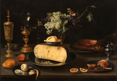 Still life with cheese and other foods on a table by Jacob van Es