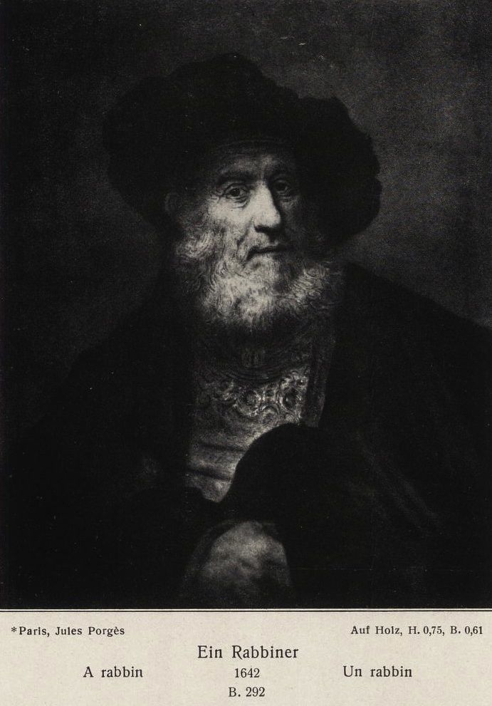 Old man with beard and beret and hand in his cloak