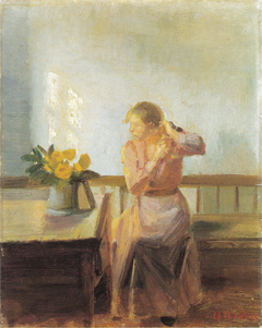 Sitting woman, plaiting her hair