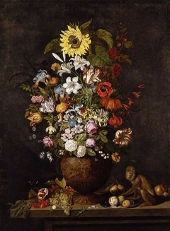 A vase of flowers with a monkey
