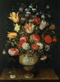 Flowers in an antique vase on a table by Philips de Marlier