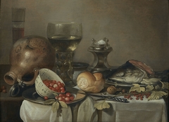 till life with a bowl of strawberries, head of a fish, roemer, and salt cellar by Pieter Claesz