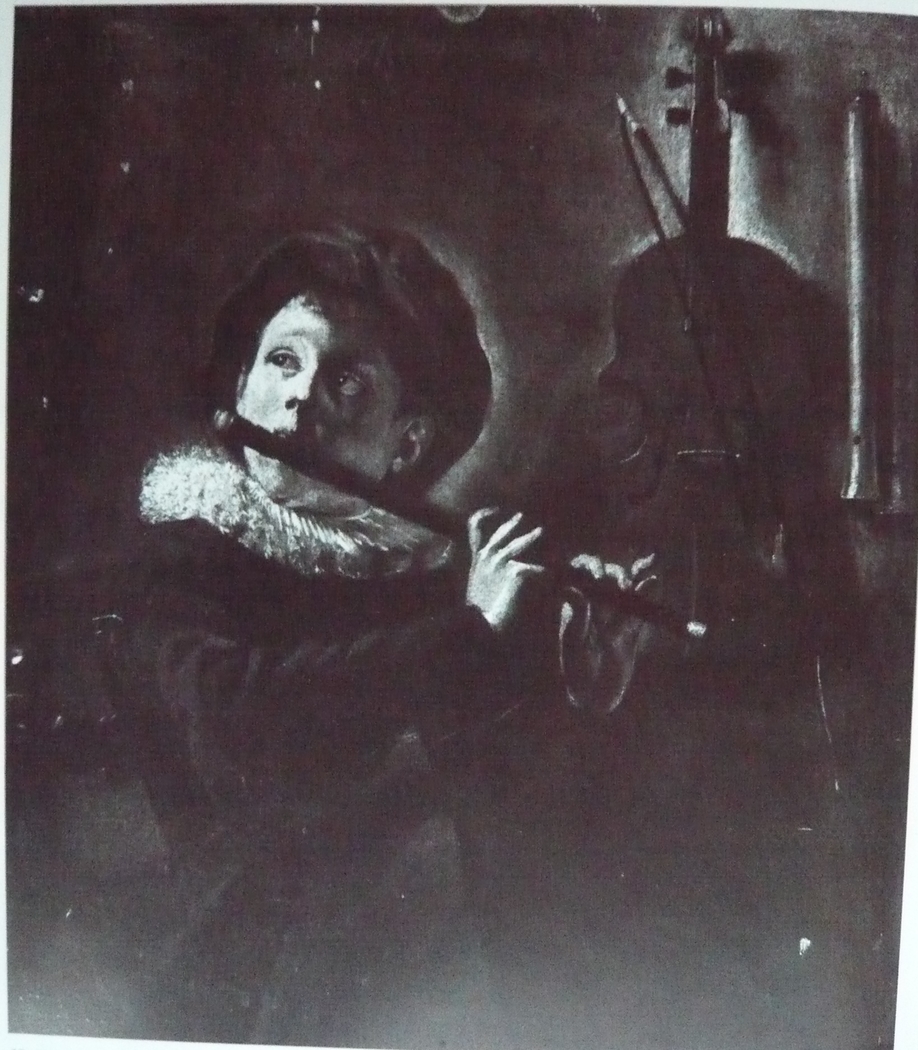 Young flute player by lamplight (with two recorders on the wall)