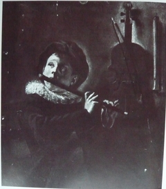 Young flute player by lamplight (with two recorders on the wall)