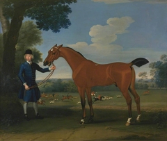 A Bay Hunter Held by a Groom, with a Stag-Hunt in the Background by Thomas Spencer